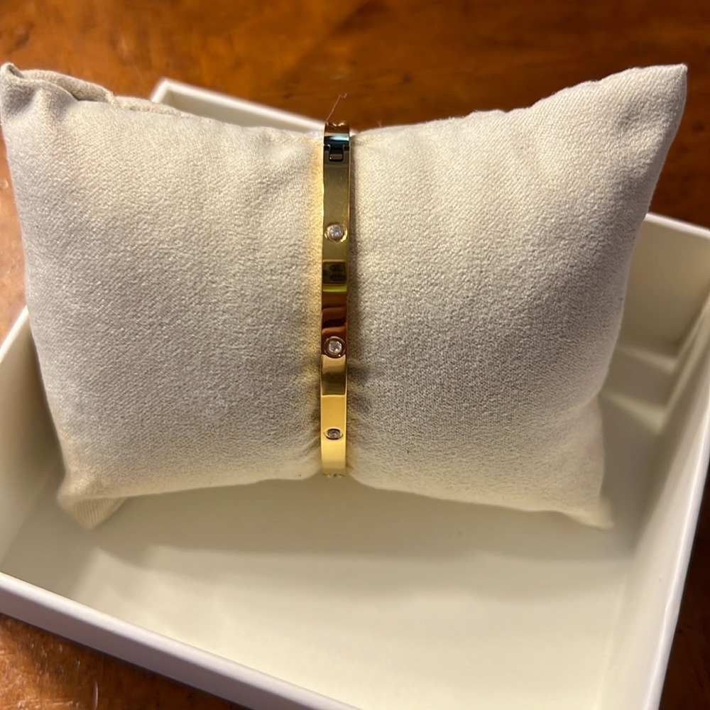 Bangle bracelet with rhinestones all around it